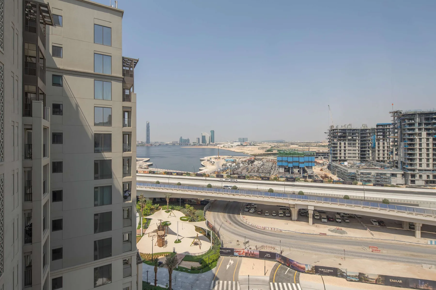 A city waterfront view with elevated roads and high-rise buildings.