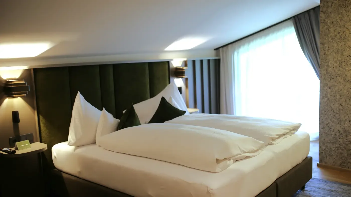 Double room with large bed and modern curtains