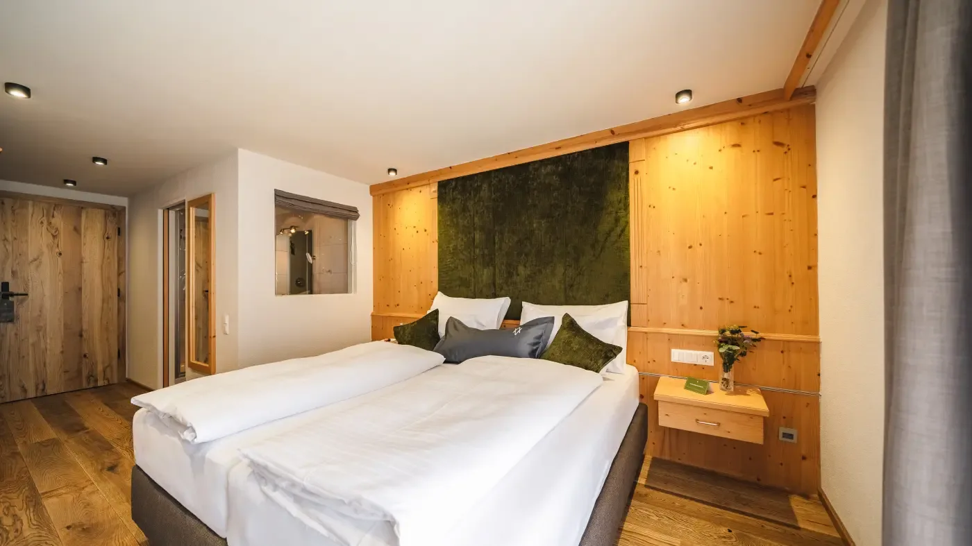 Guest room with double bed and wood accents