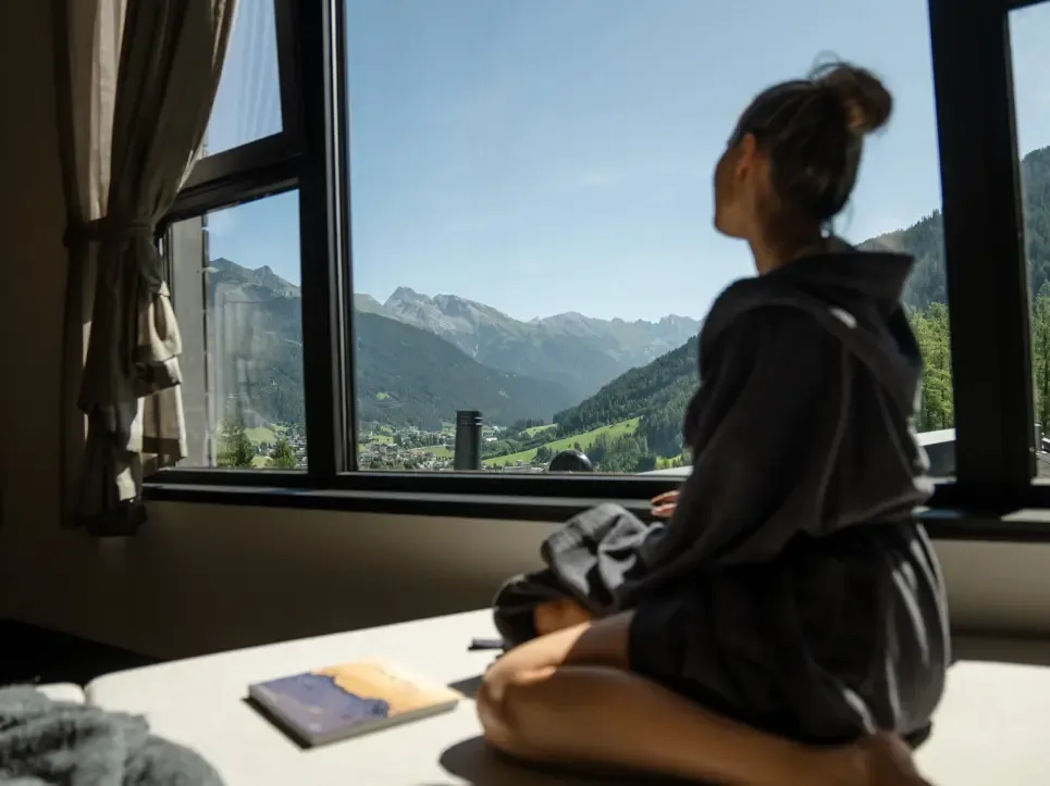 Guest enjoying the mountain view from a window