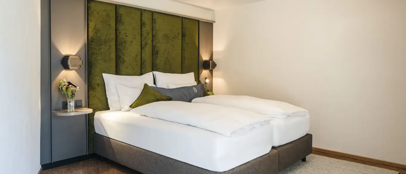 Bedroom with double bed and green headboard
