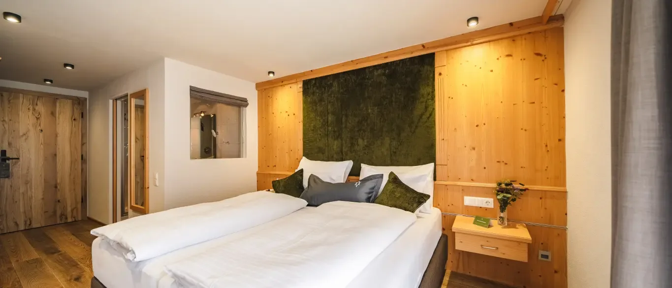 Guest room with double bed and wood accents