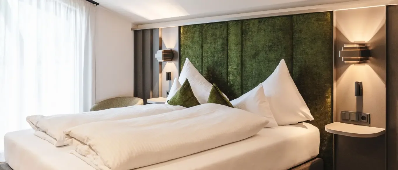Modern hotel room with green headboard