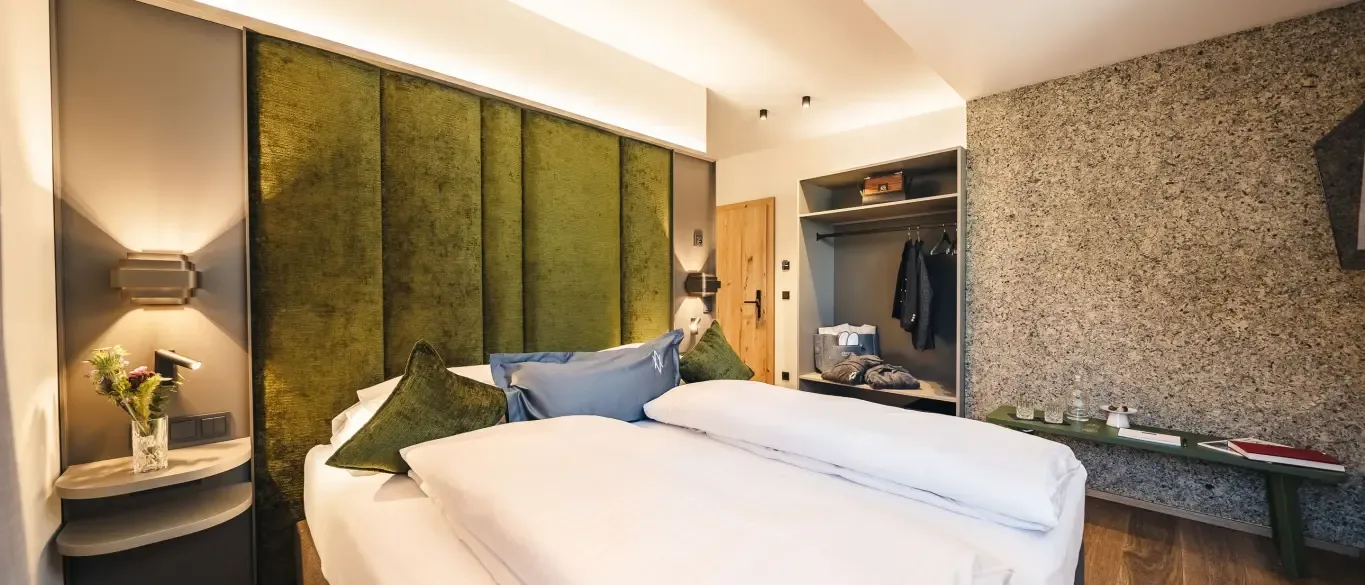 Hotel room with green headboard