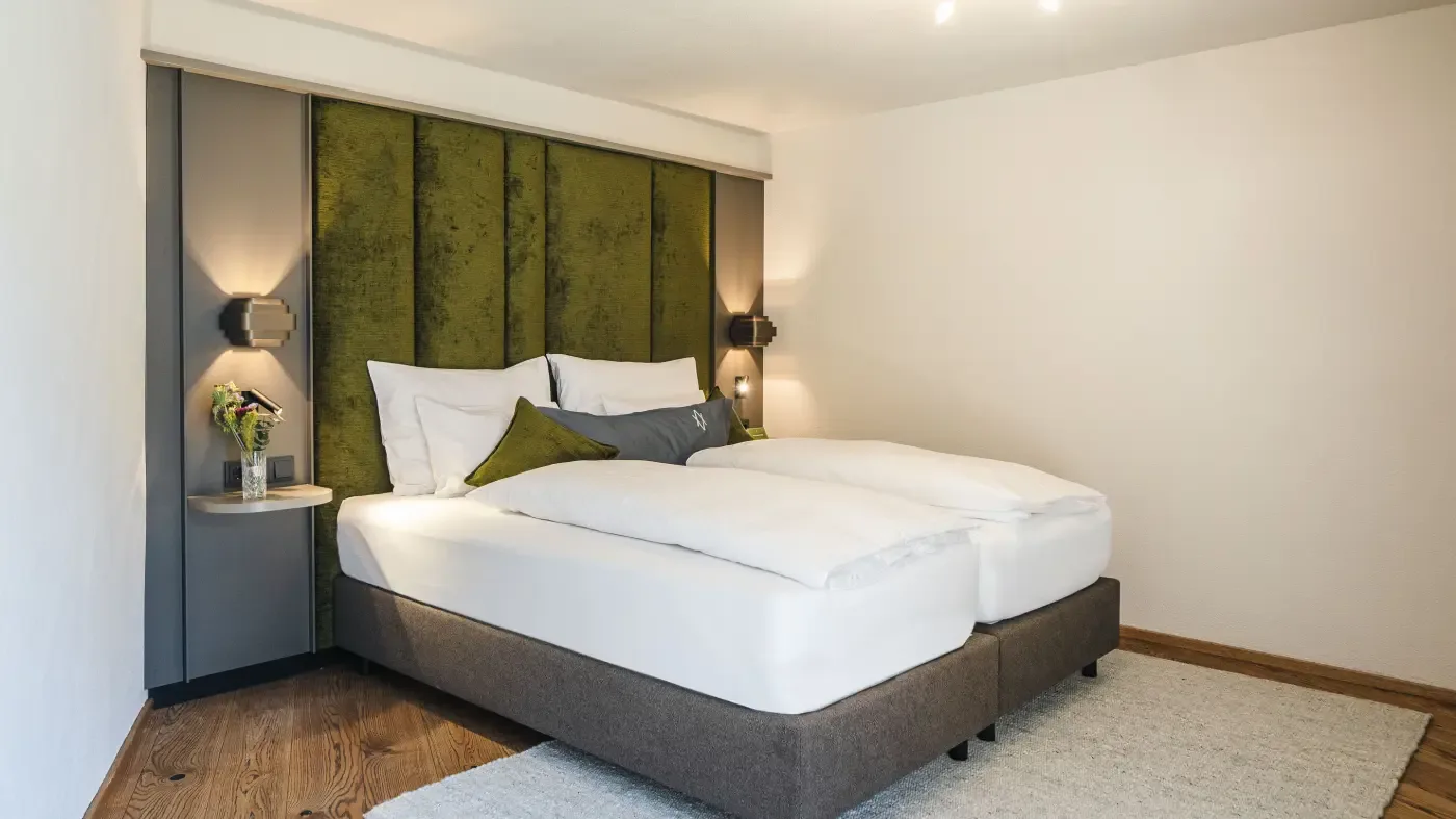 Bedroom with double bed and green headboard