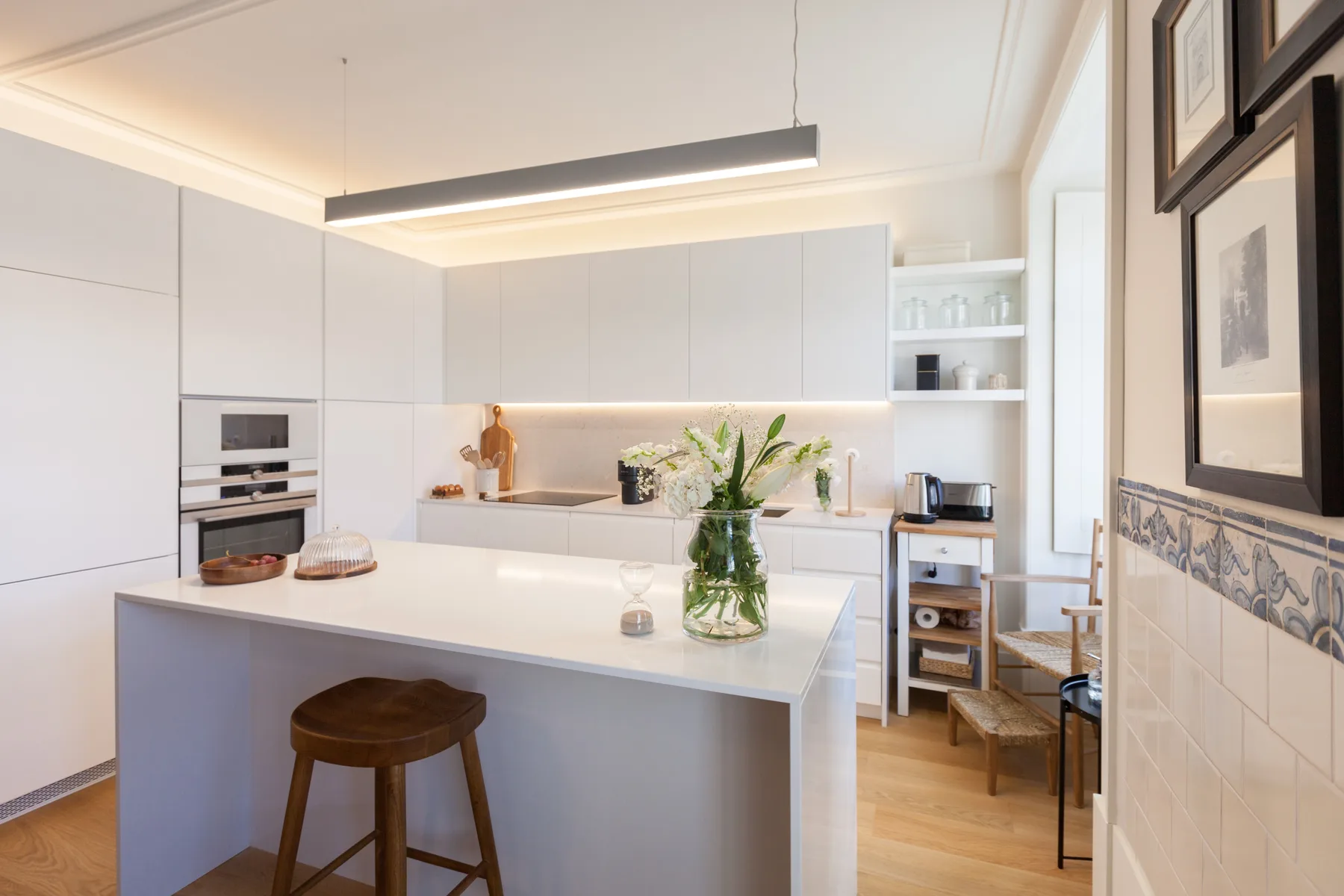 A bright modern kitchen with white cabinetry and a central island.