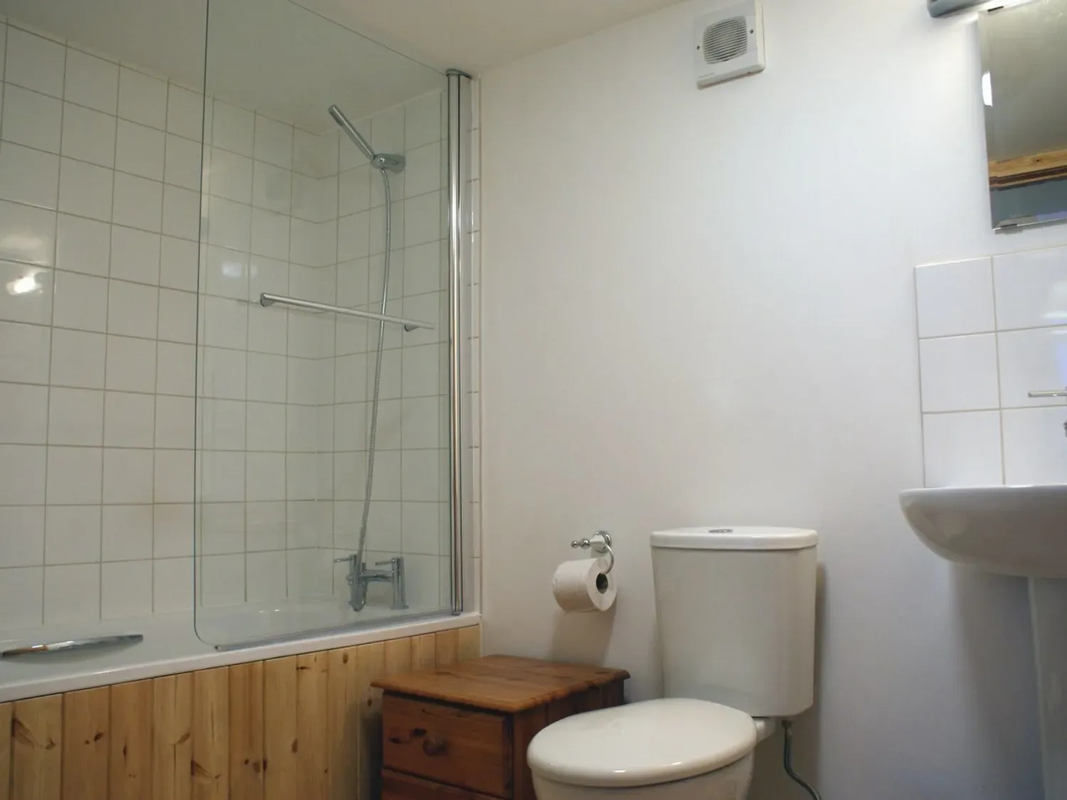 Un baño alicatado con bañera, ducha, inodoro y lavabo.