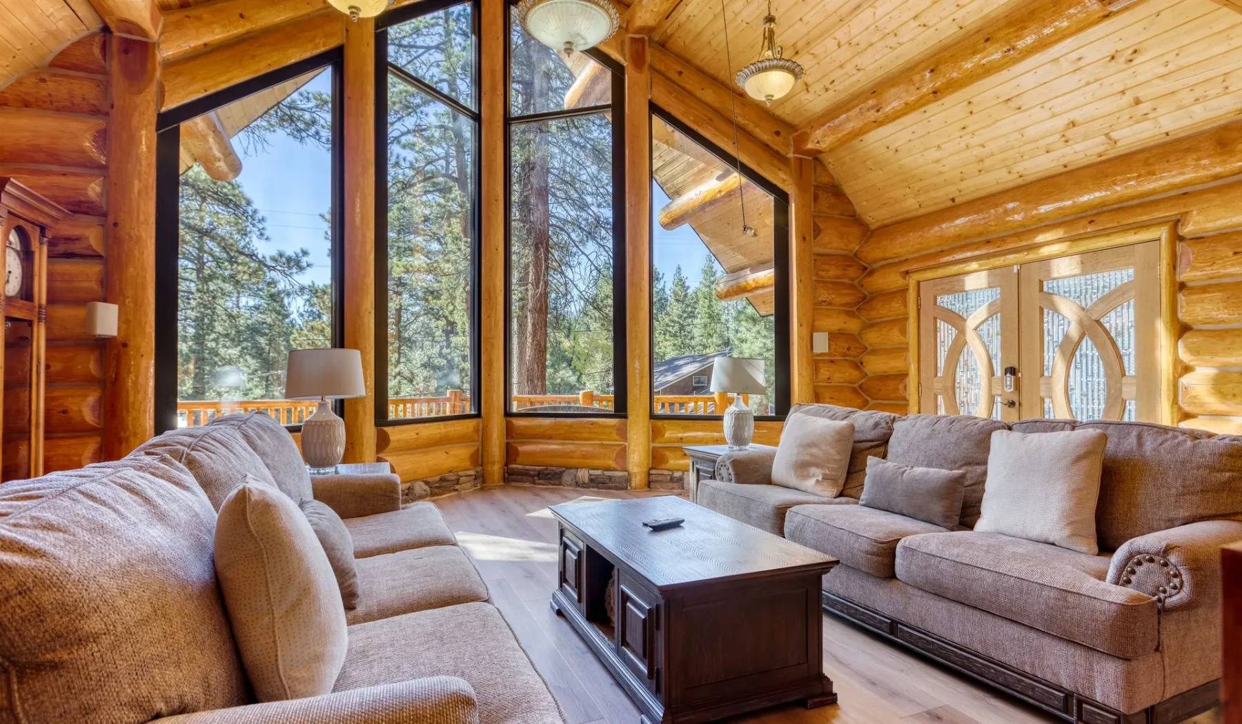A wood-paneled living room with seating arranged around a coffee table.