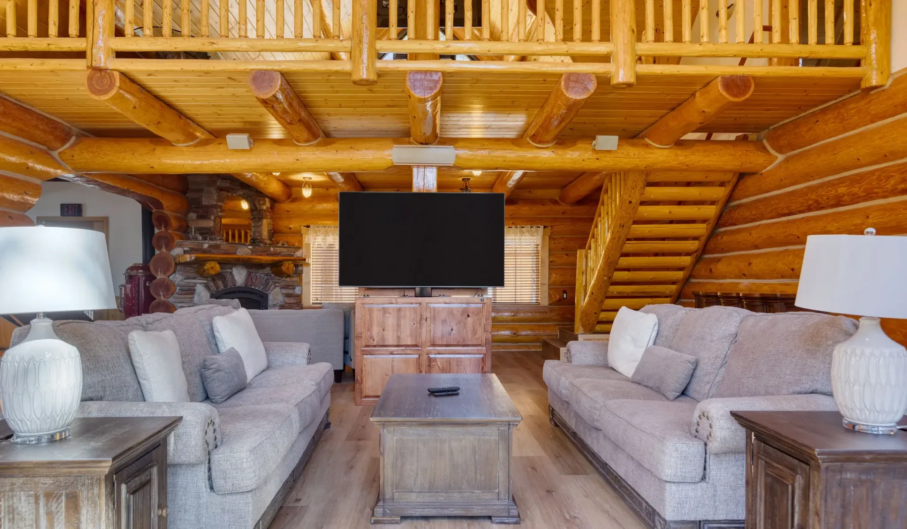 A wood-paneled living room with seating facing a television.