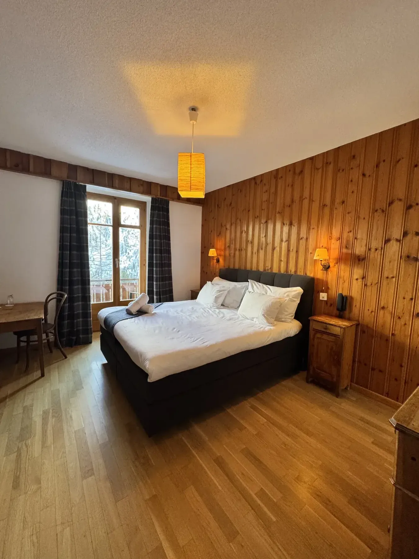 Double room with Swiss stone pine paneling and balcony access