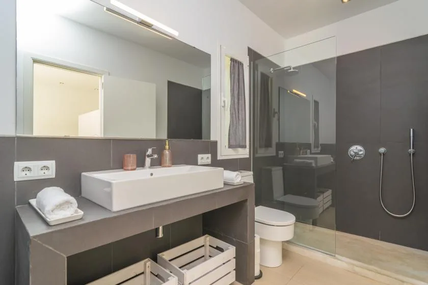 A modern bathroom with a wide vanity and glass shower.