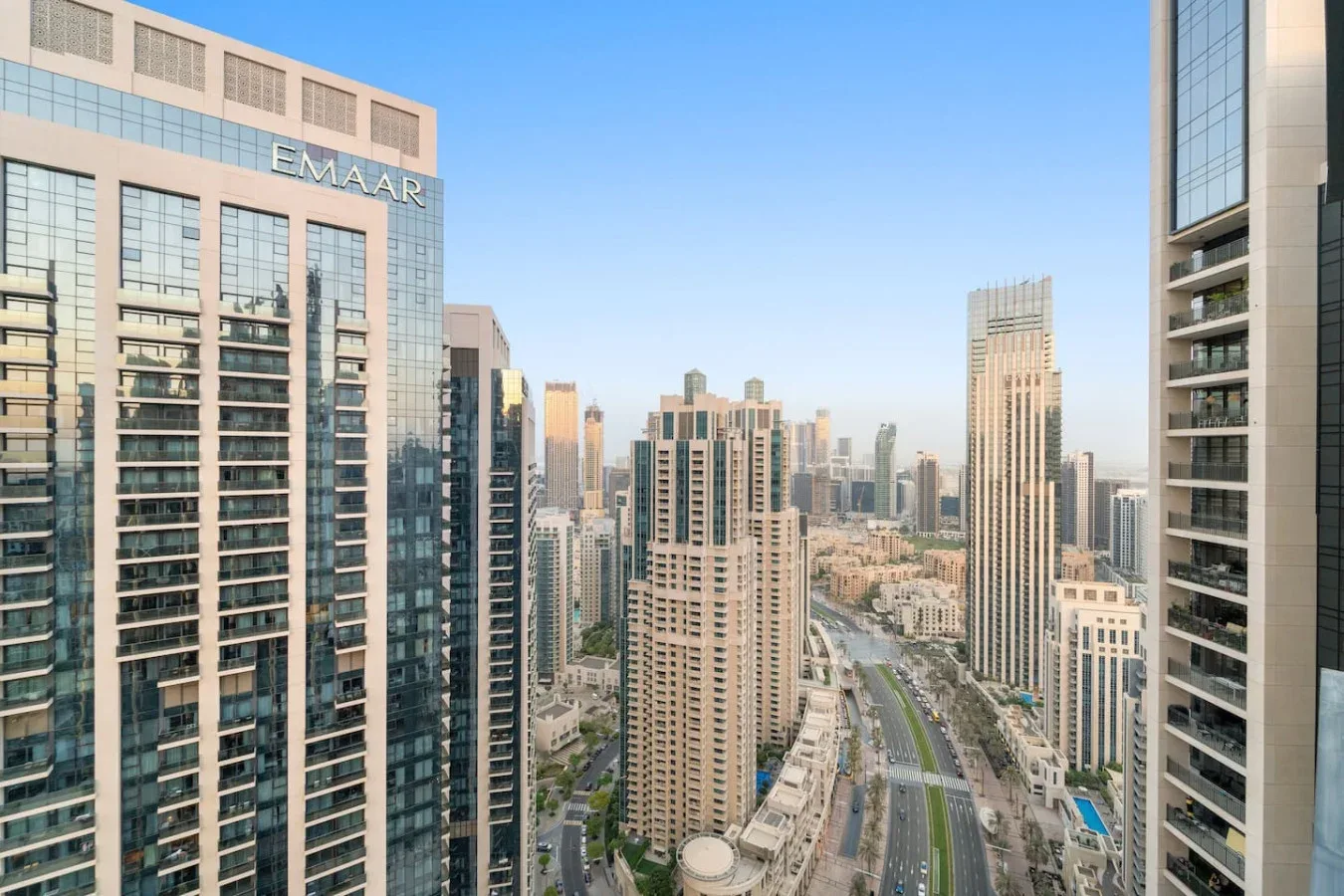 A city skyline with high-rise buildings and a road below.