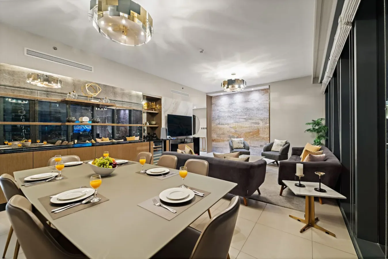 A modern dining and living area with a set dining table and seating.