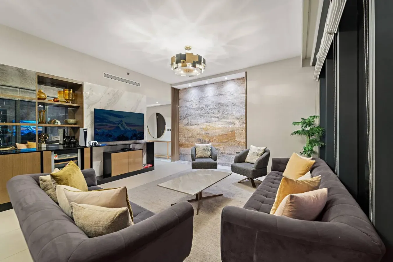 A modern living room with seating arranged around a low coffee table.