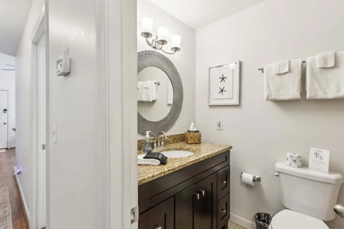 Bathroom with a vanity, mirror, and toilet.