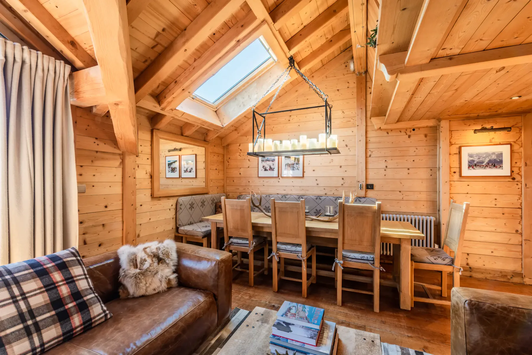 A wood-paneled dining and living area with a table, chairs, and seating.