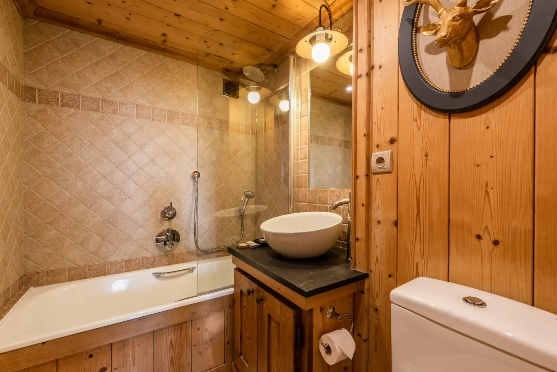 A bathroom with a bathtub, sink, and wood-paneled walls.