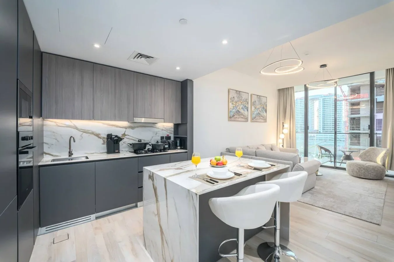 Cocina y comedor modernos de planta abierta con grandes ventanales.