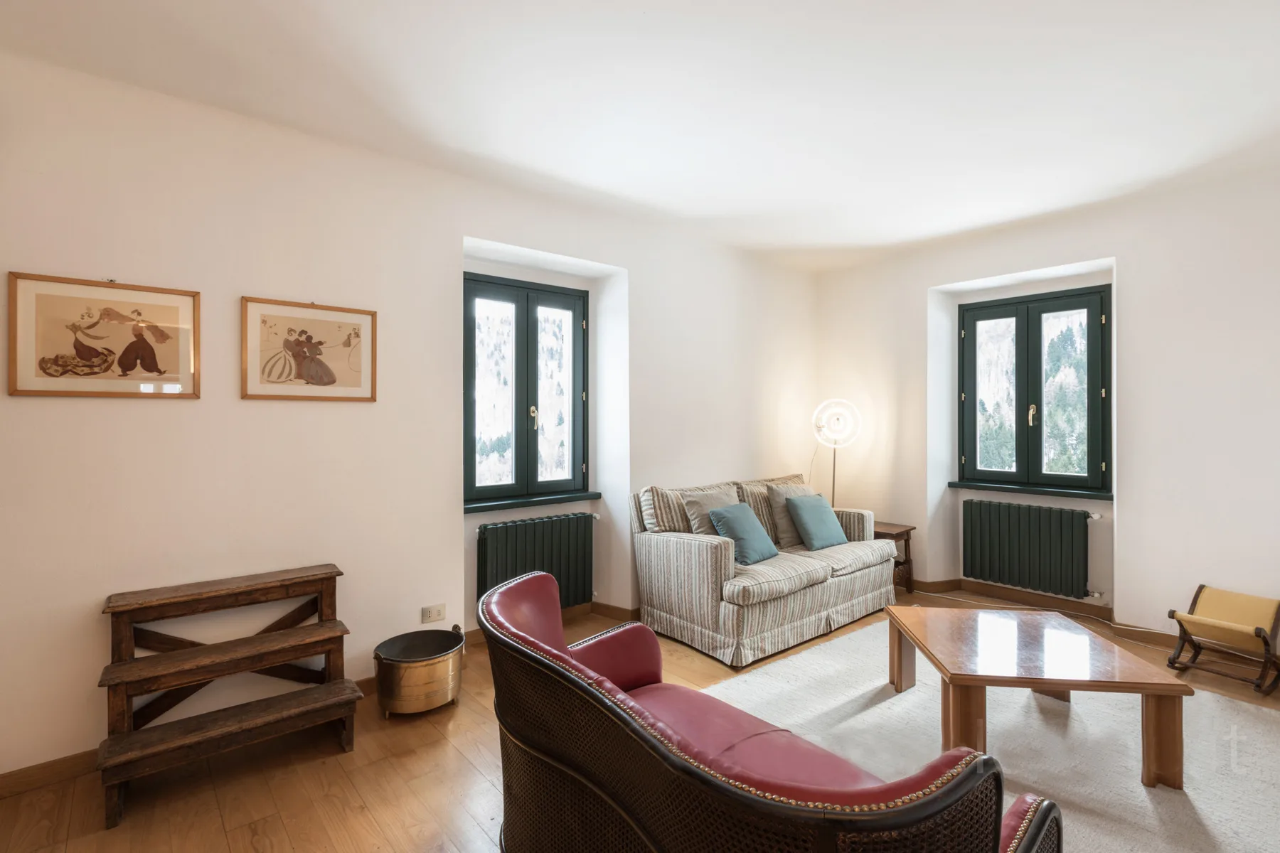 A bright living room with seating and a coffee table.