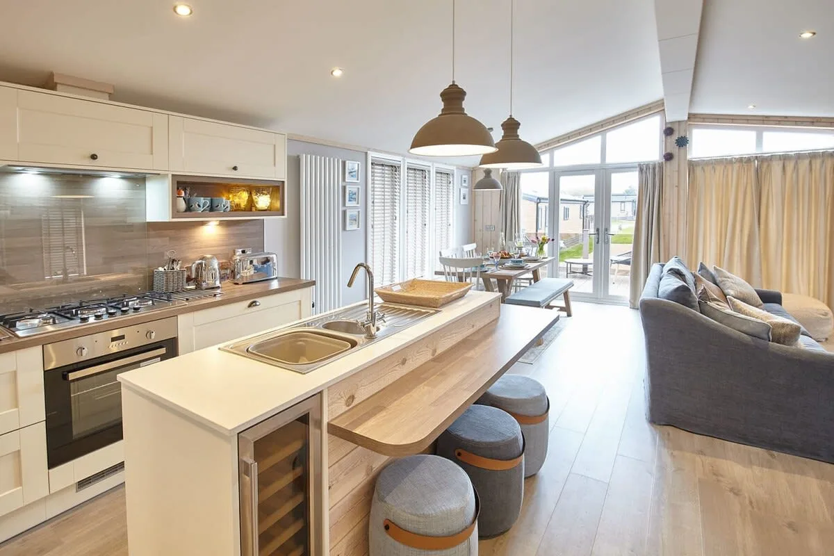 An open-plan kitchen and dining area with a central island and adjoining seating.