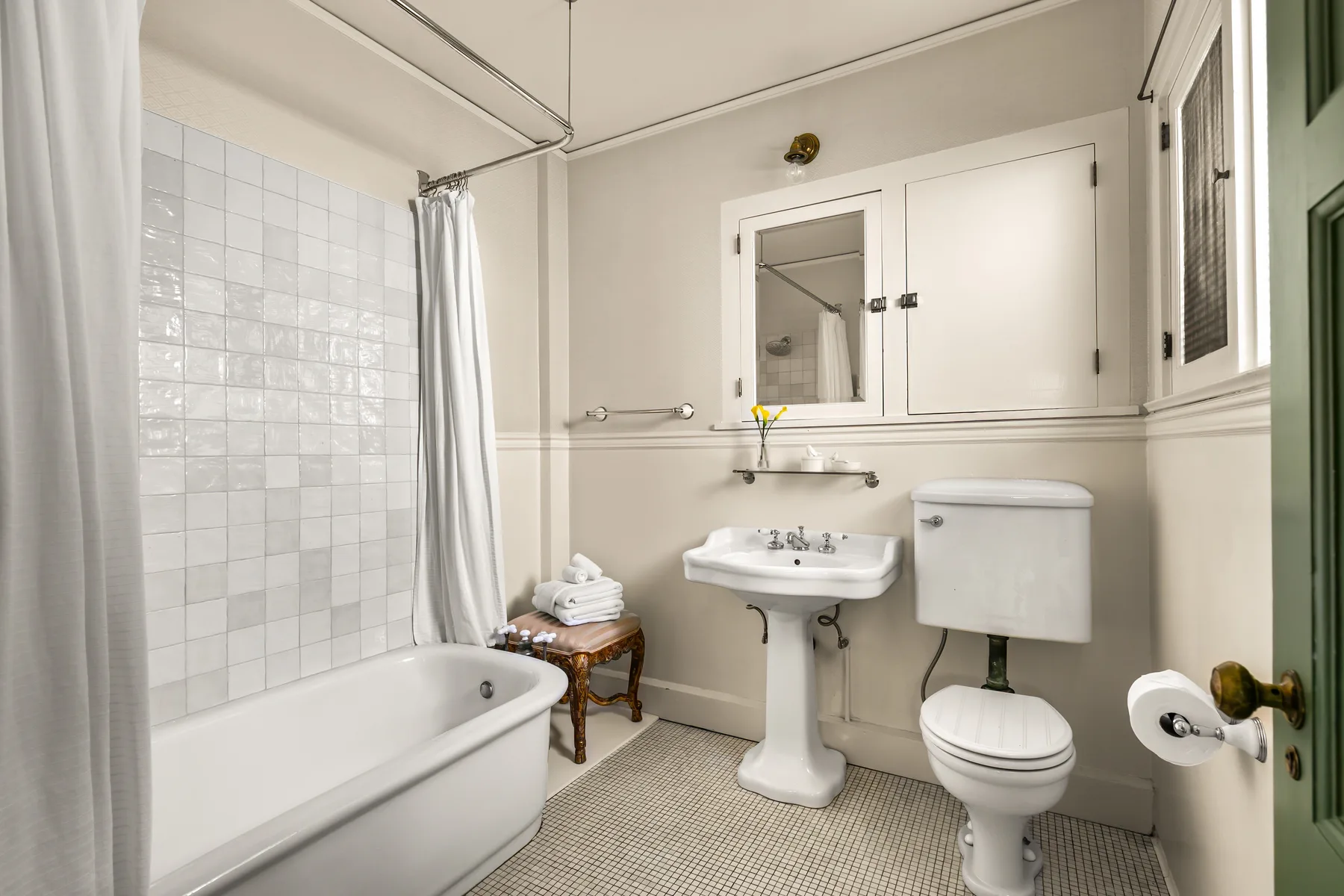 A bathroom with a bathtub, sink, and toilet.