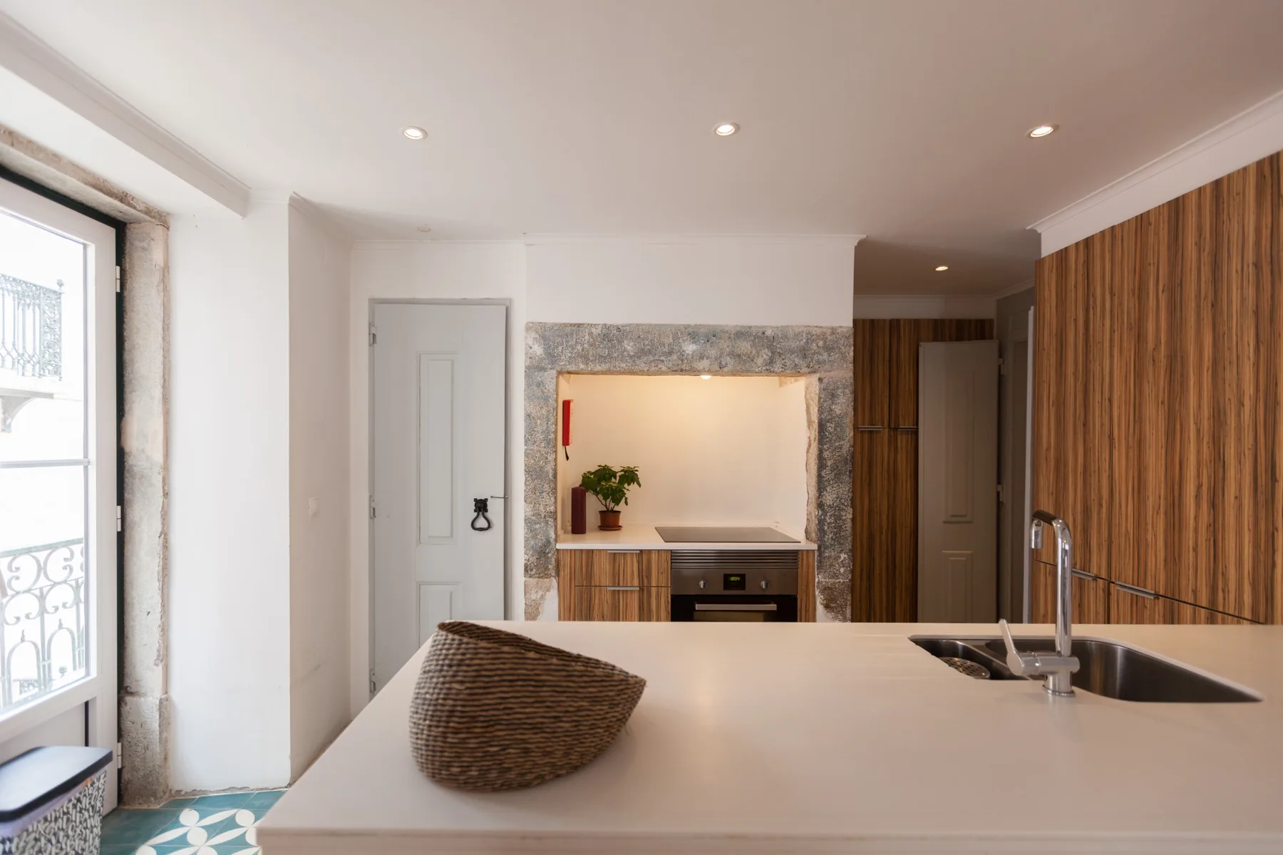A bright kitchen with a wide island and a small dining nook.
