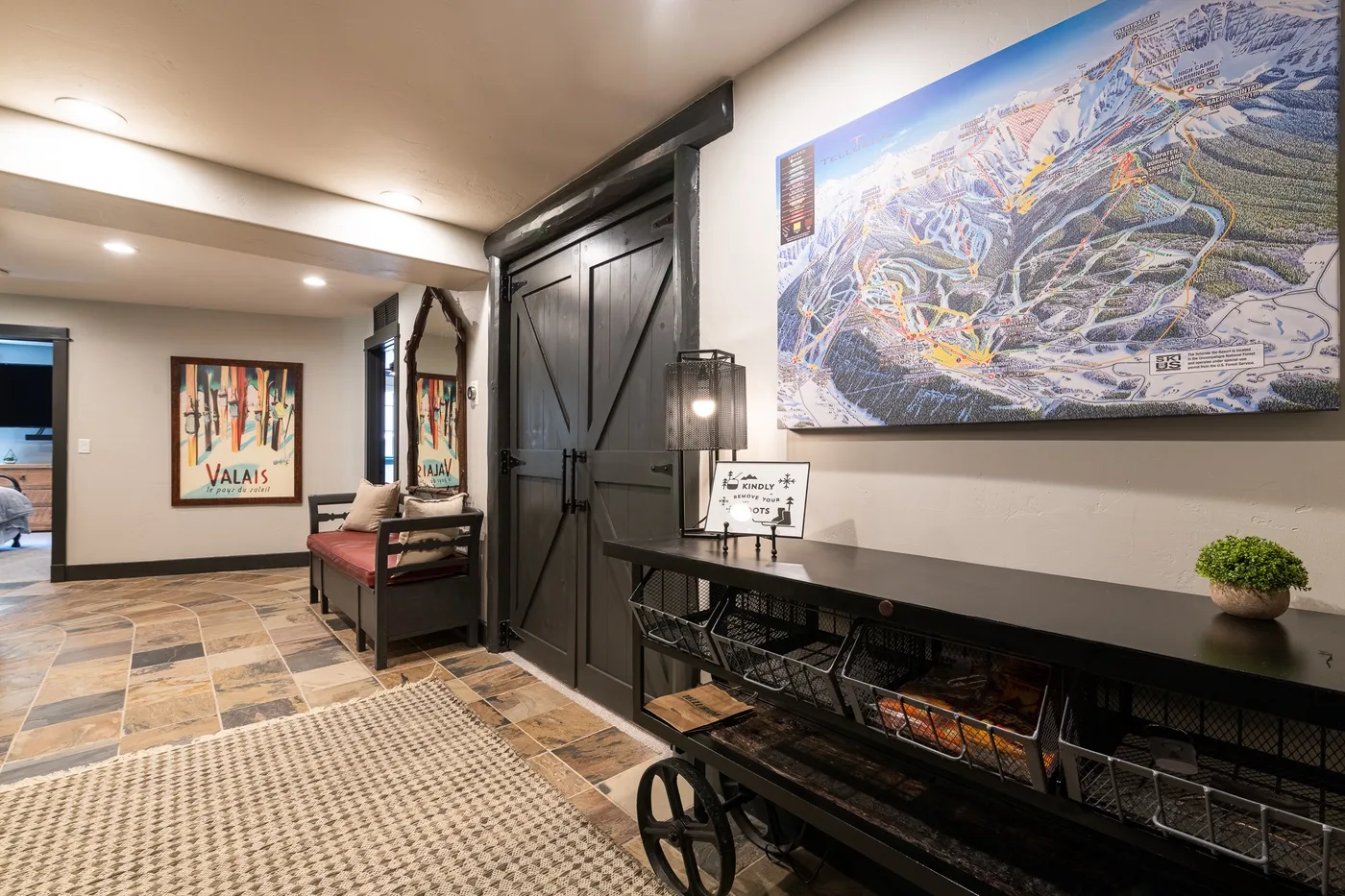 A lodge lobby features a large wall map above a long console table.