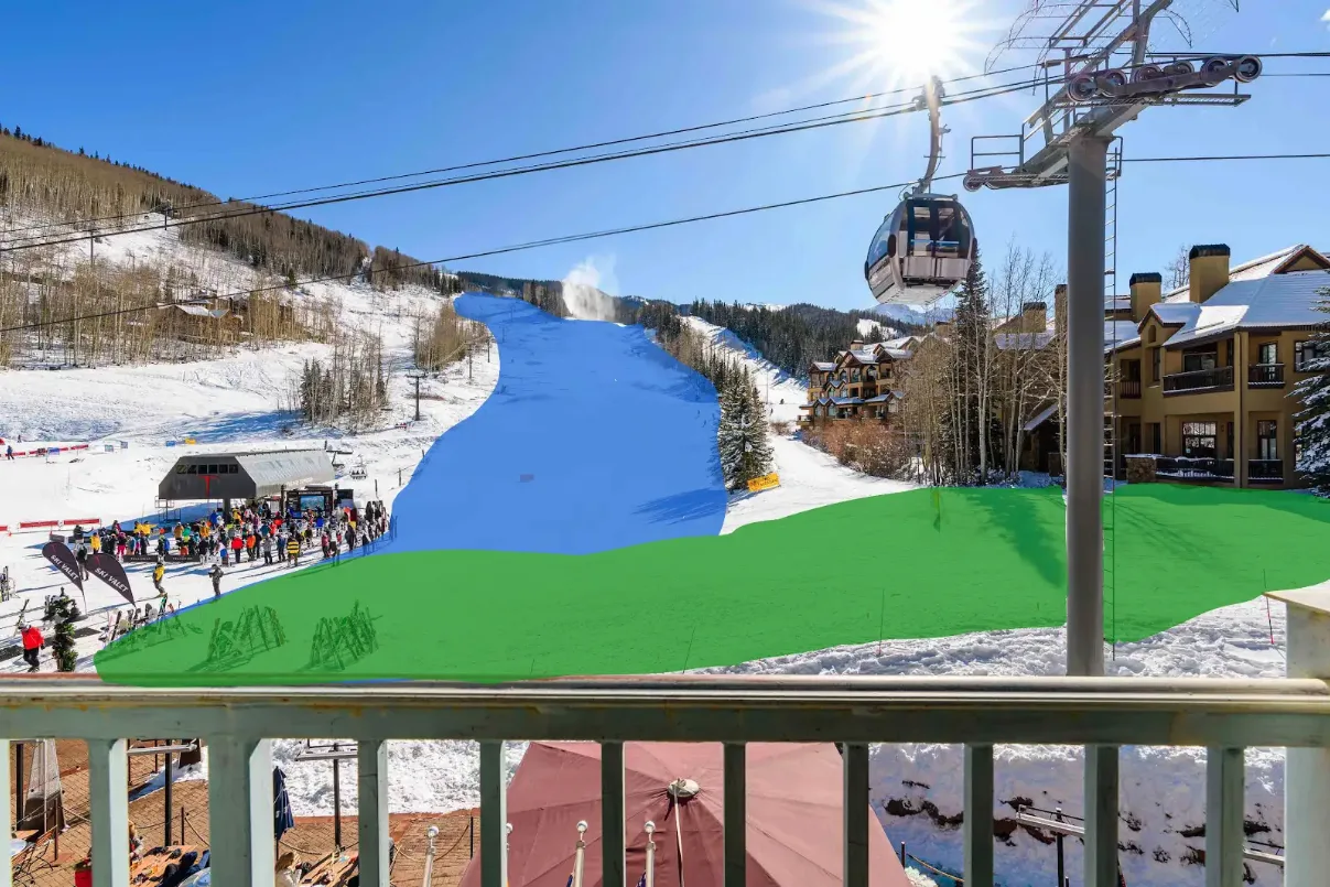 A snowy ski slope with a gondola lift and lodge buildings.