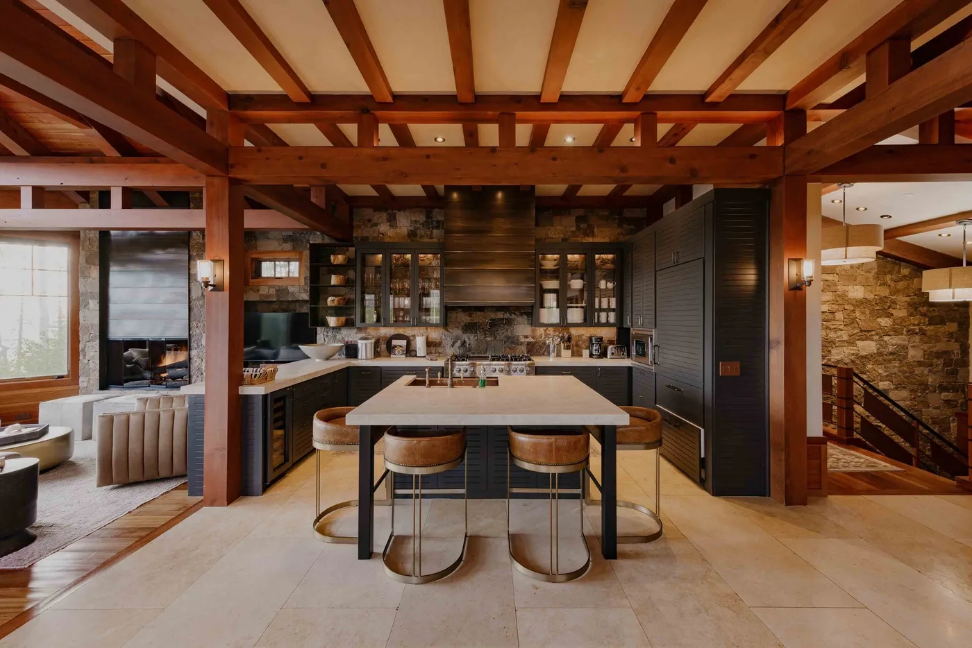 A spacious kitchen with a central island and exposed wooden ceiling beams.