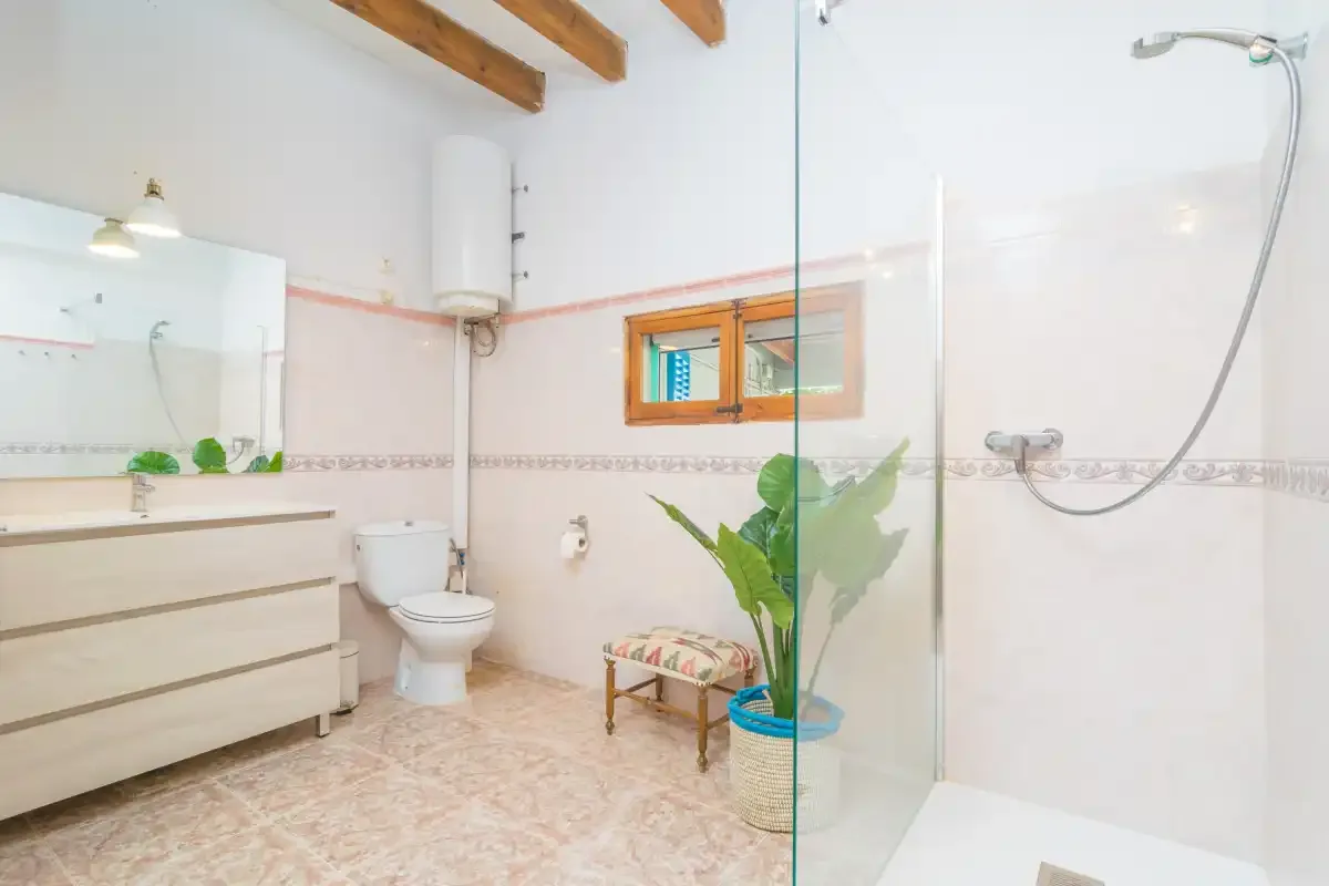 A bathroom with a sink, toilet, and shower.