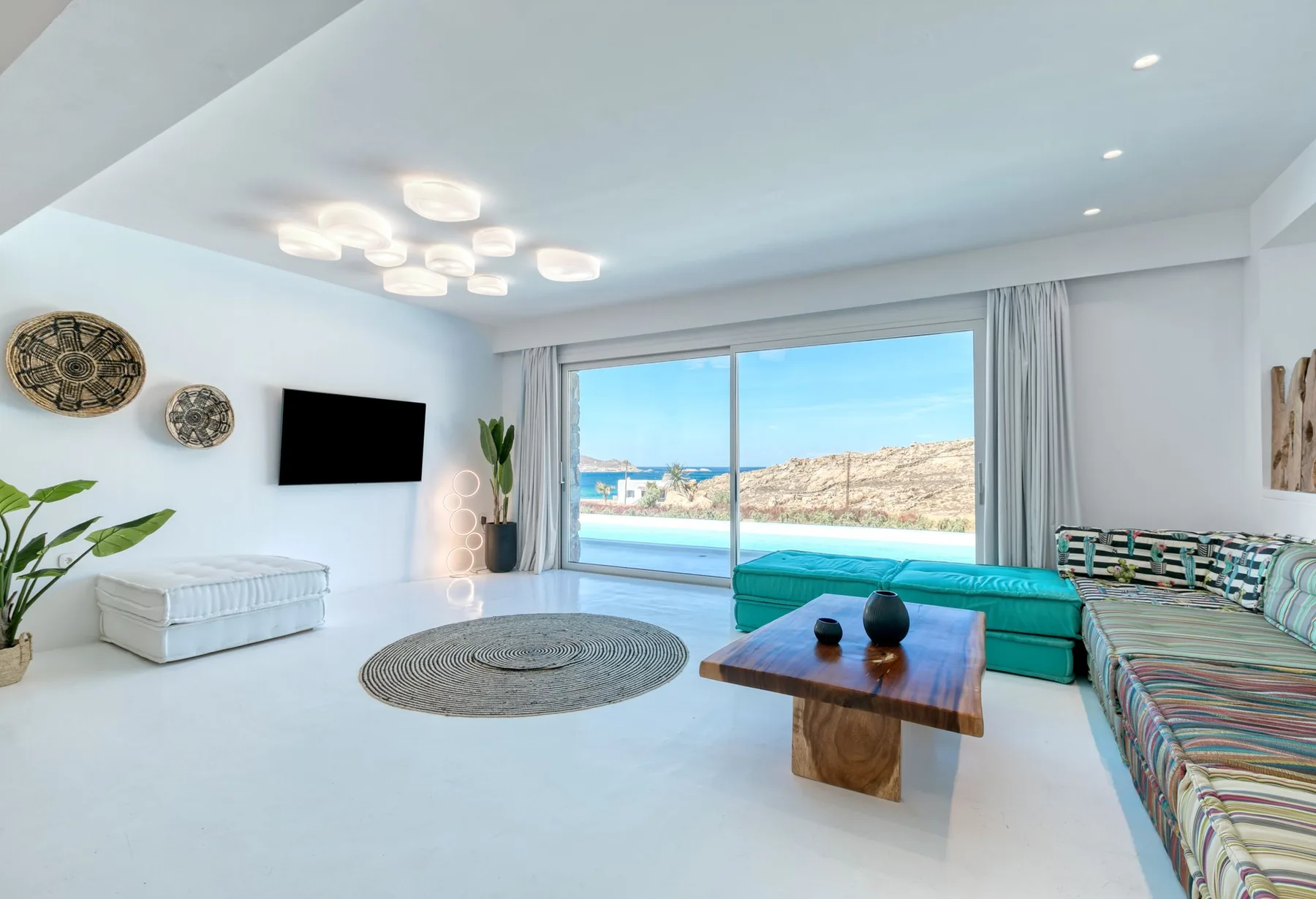 A bright living room with seating arranged around a low wooden table.
