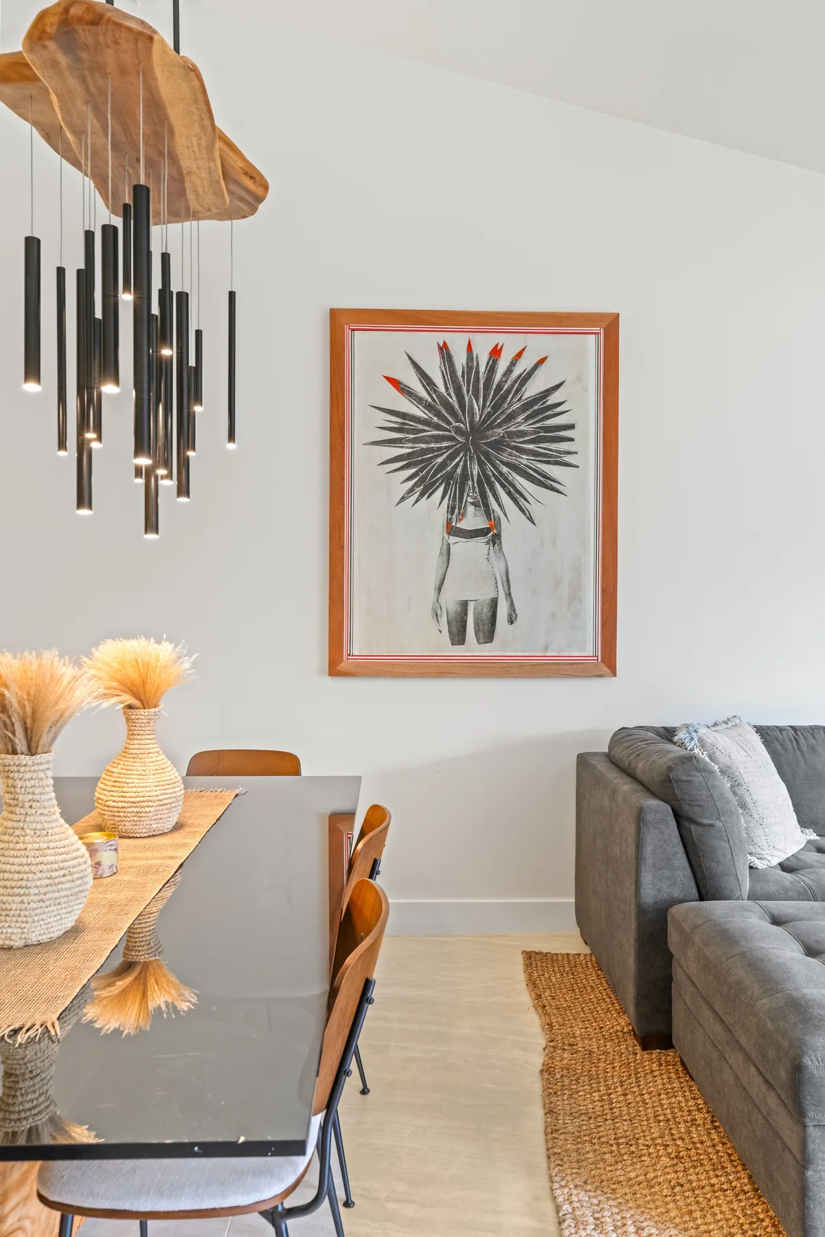 Living room with seating, a dining table, and framed botanical artwork.