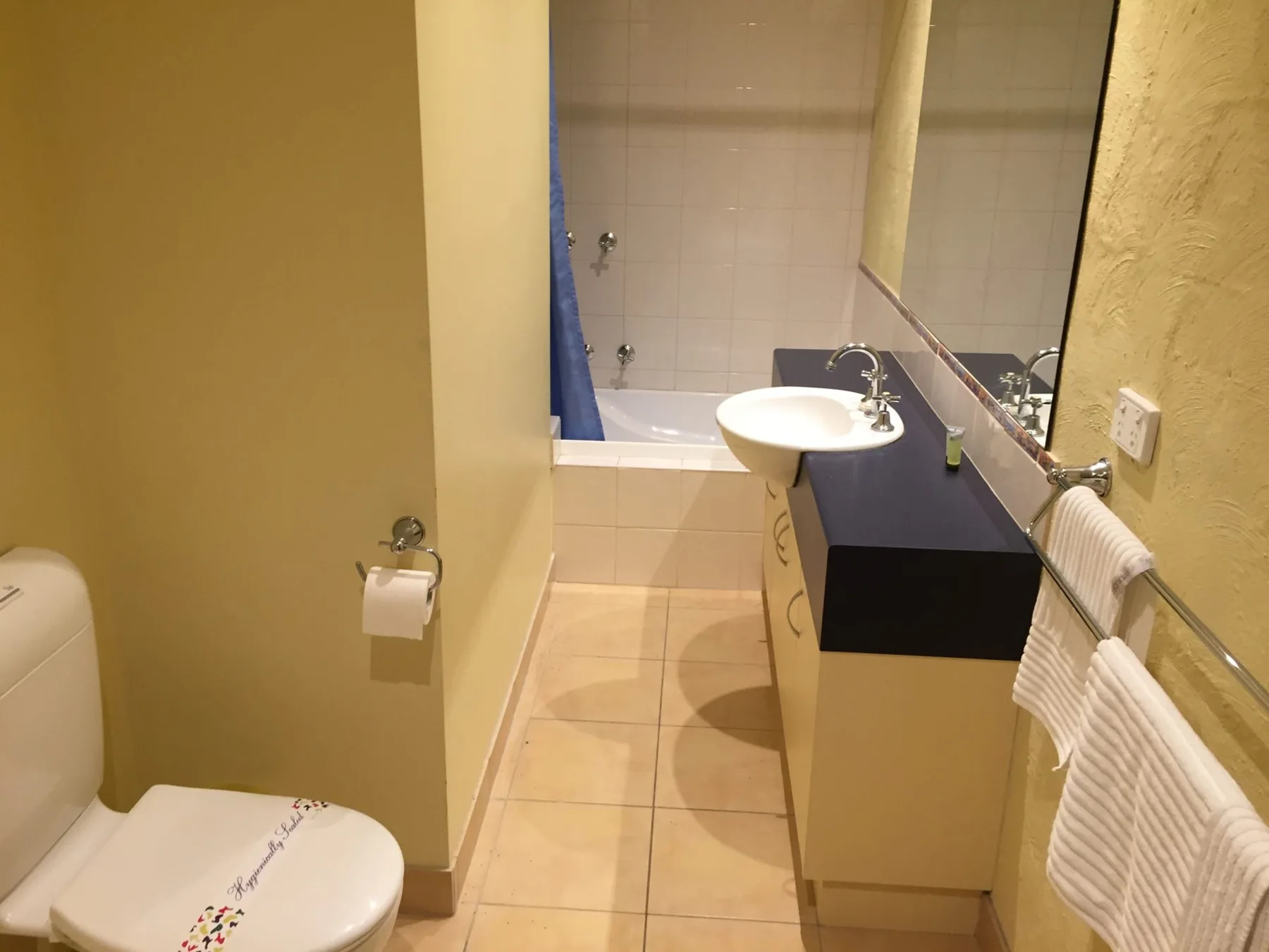 A bathroom with a sink, toilet, and bathtub.