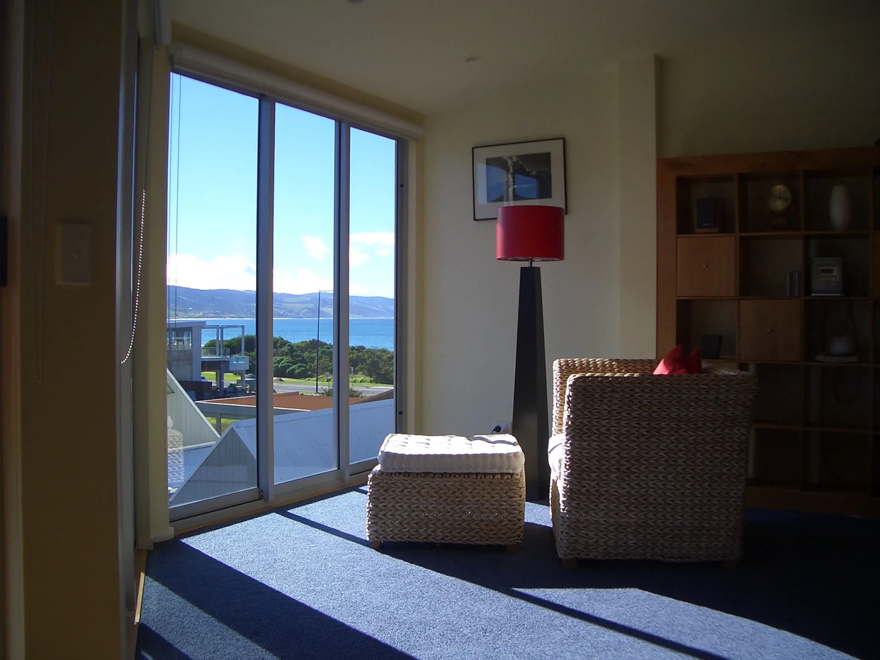 A sitting area with a large window overlooking the water.