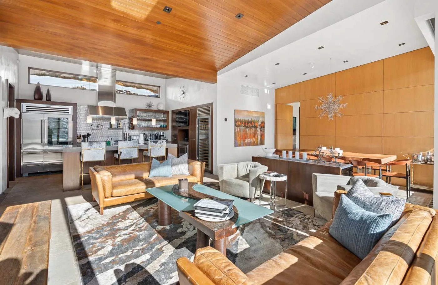 An open-plan lounge and dining area features seating around a low table.