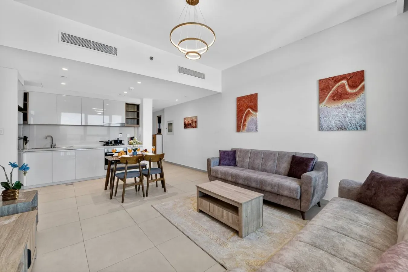 Una luminosa sala de estar abierta con mesa de comedor y cocina.