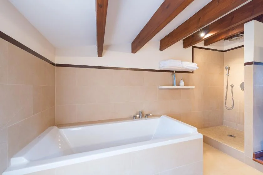 A bathroom with a large bathtub and a shower area.