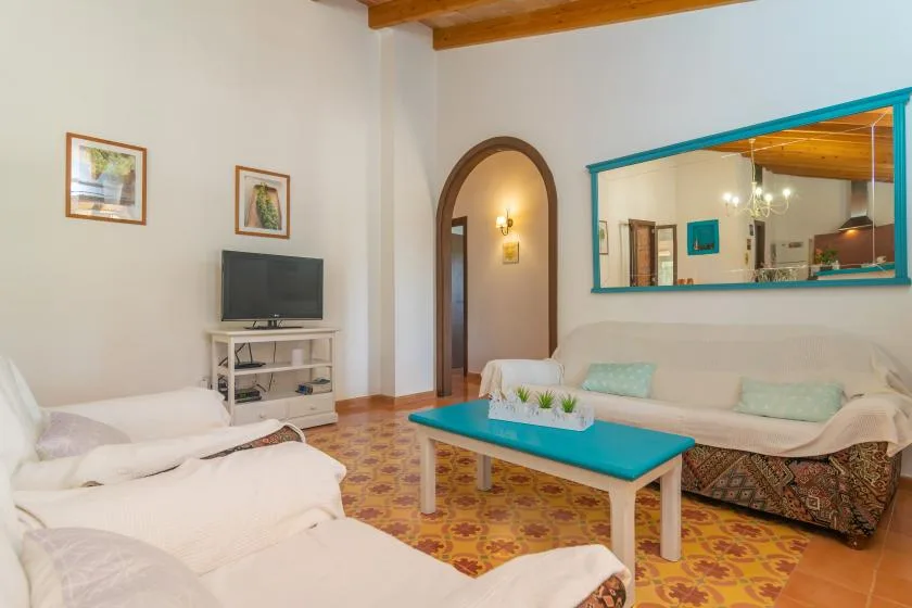 Una sala de estar con una mesa de centro turquesa y asientos alrededor.