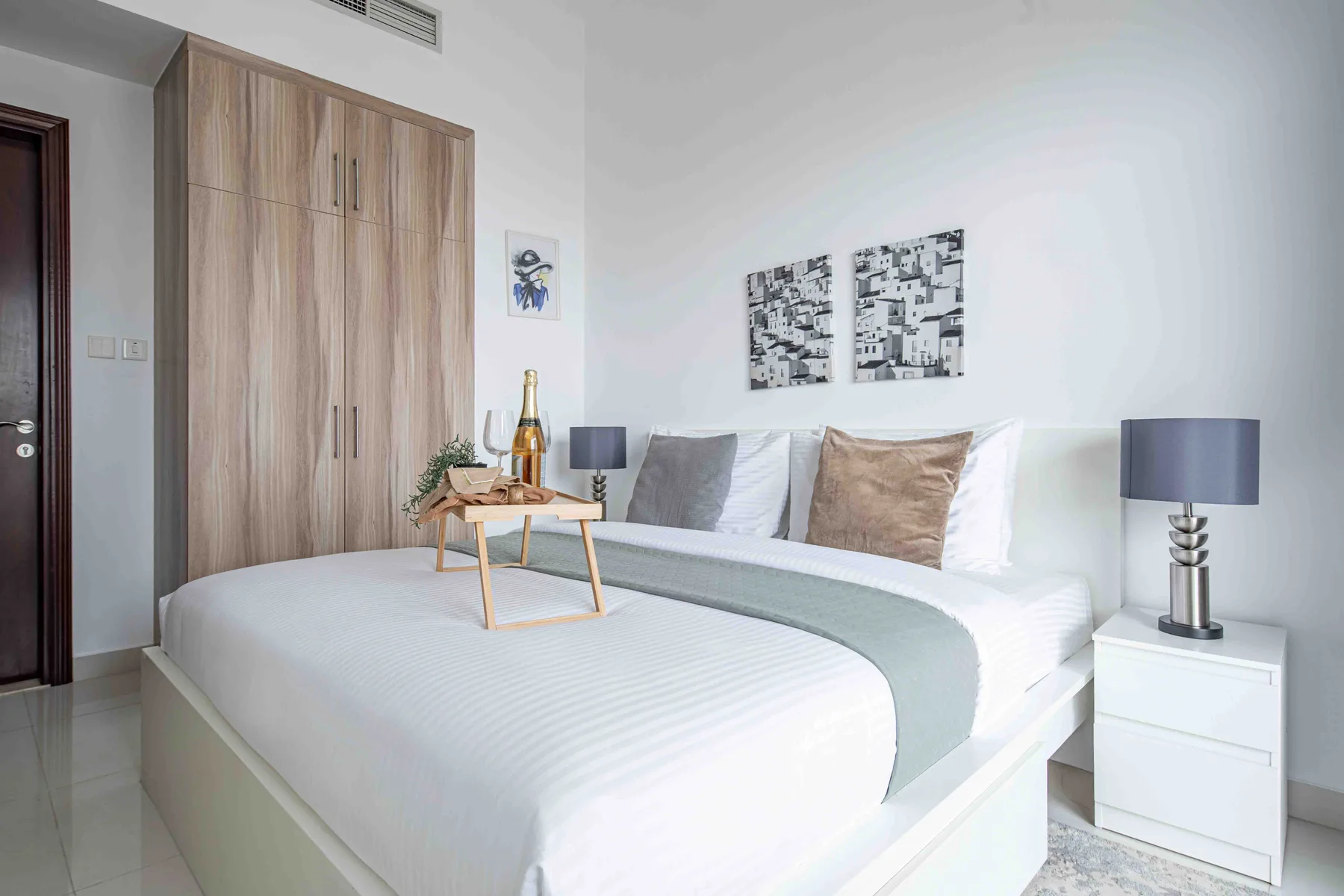 Un dormitorio con una cama tendida y un armario de madera.