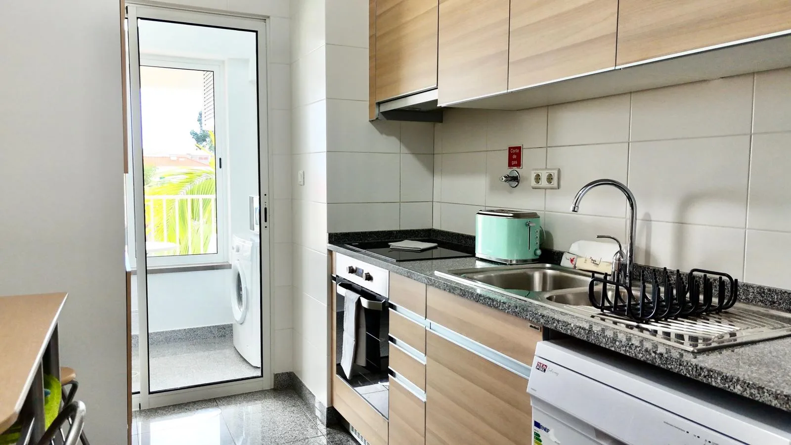 A modern kitchen with wood cabinets and a countertop.