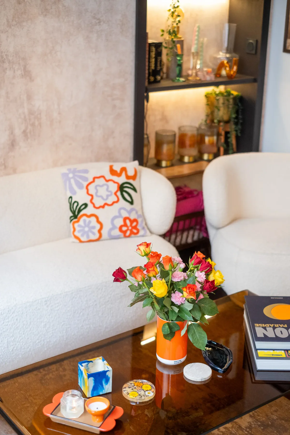 A bright lounge seating area with a floral cushion and a coffee table.