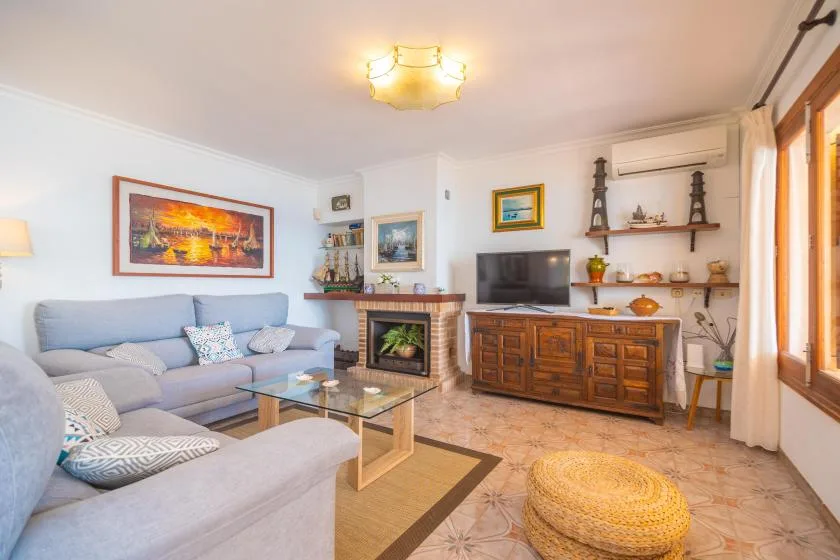 A living room with seating, a television, and a wooden coffee table.