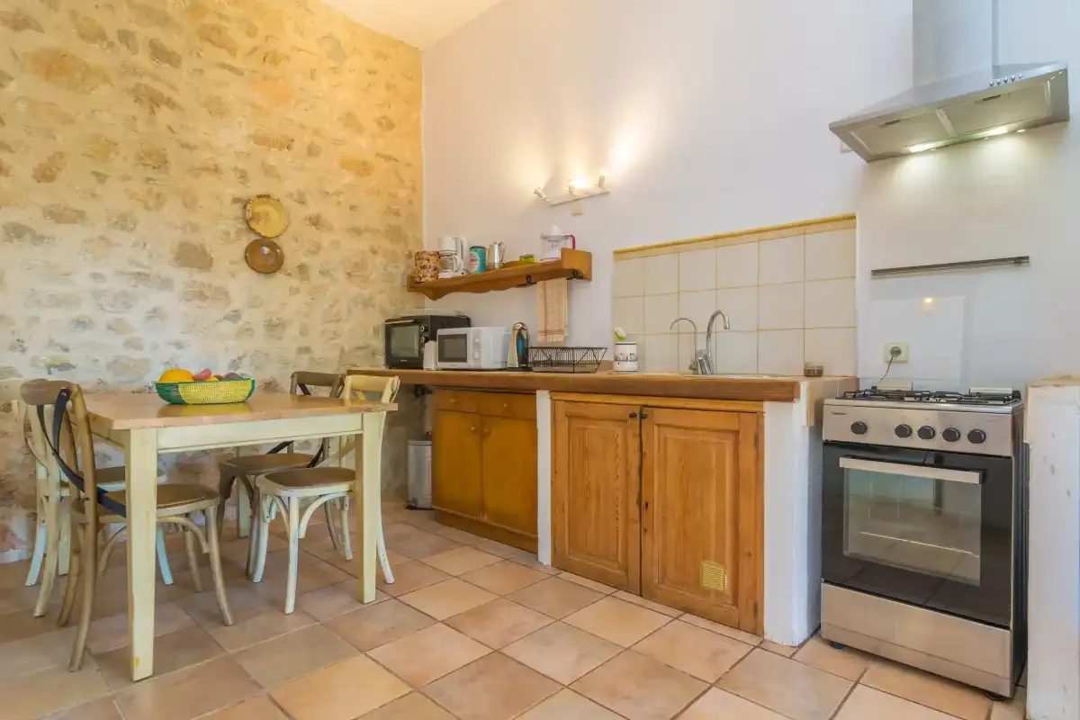 A kitchen and dining area with wooden cabinets and a table.
