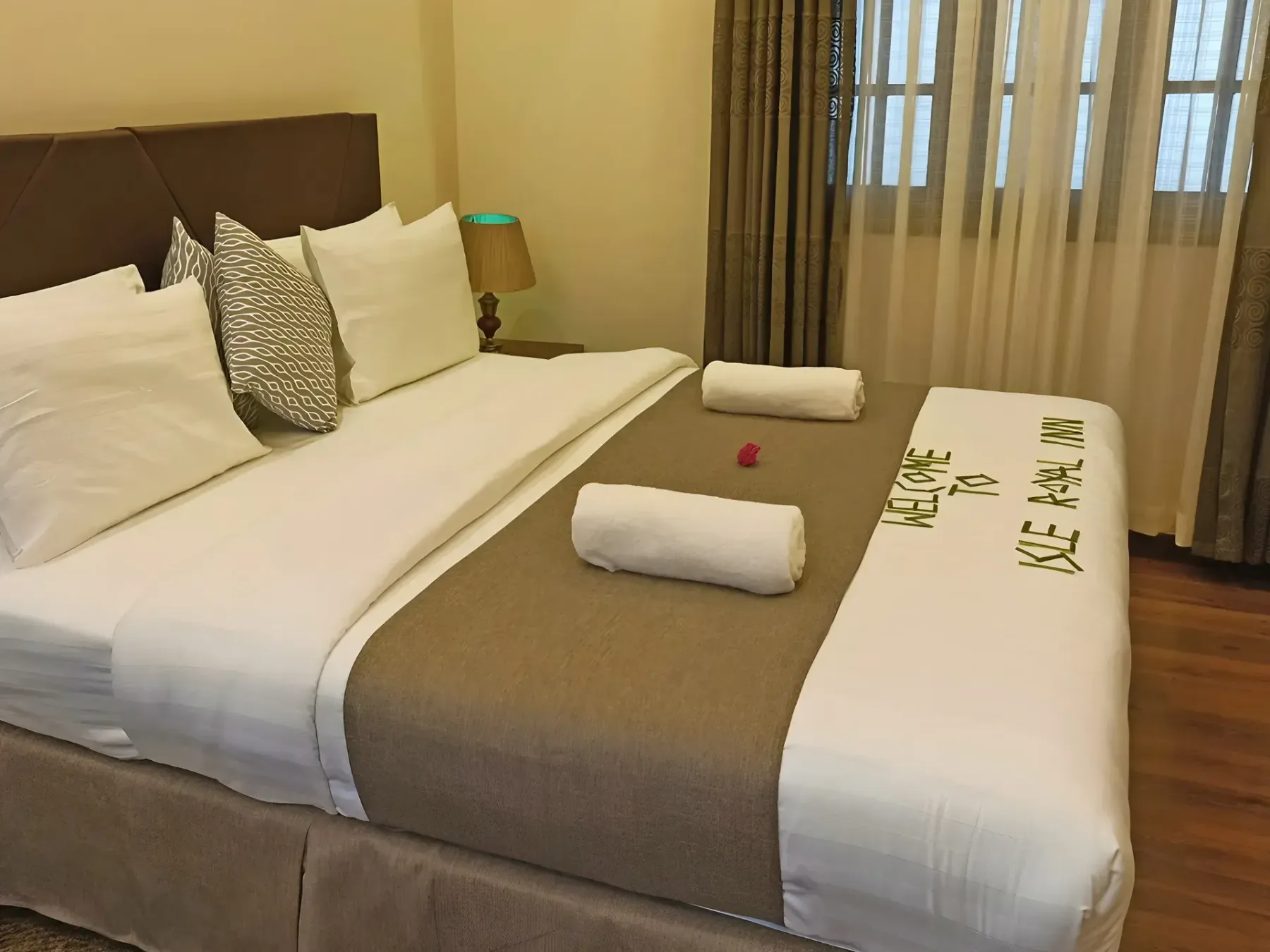 A double bed made up with a welcome message
