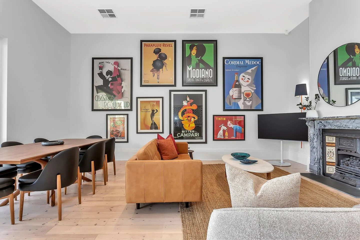The living area blends soft textures, curated art and natural light to create a calm, inviting space for gathering, relaxing or entertaining.