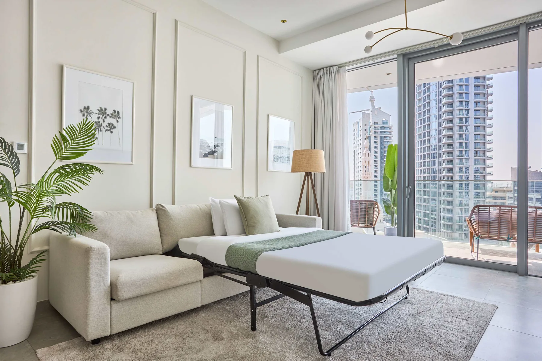 A bright living room with seating, a coffee table, and large windows.