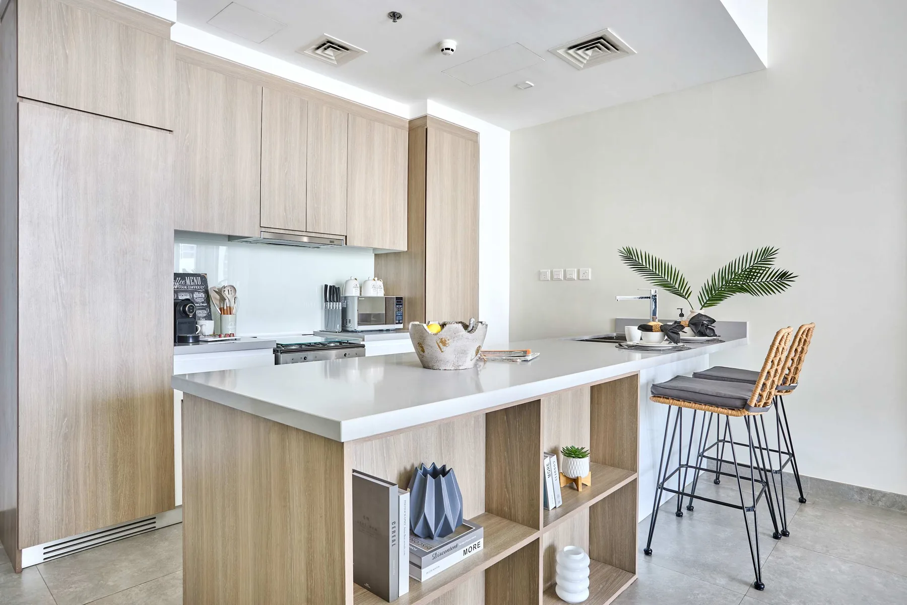A bright kitchen with a large island and bar stools.