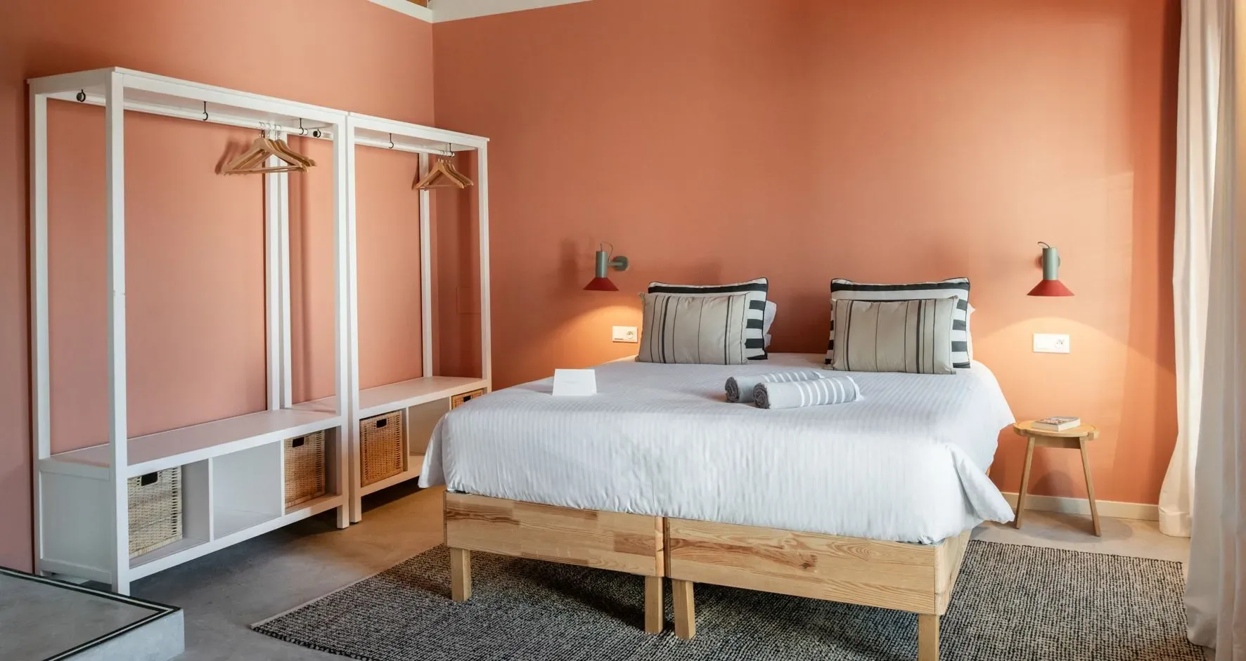 A guest room with a bed and rug.
