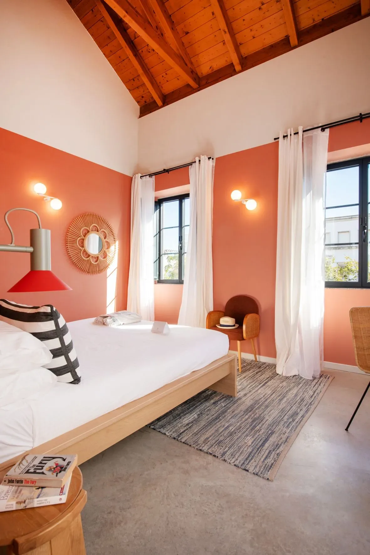 A guest room with a bed, chair, and table.