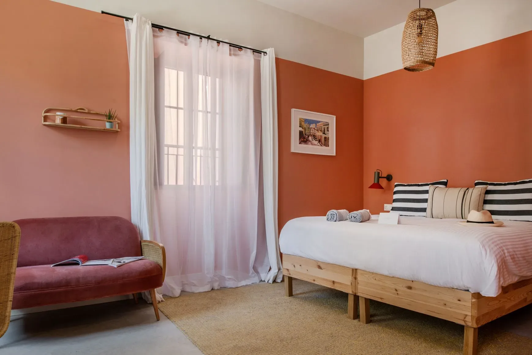 A guest room with a bed and couch.